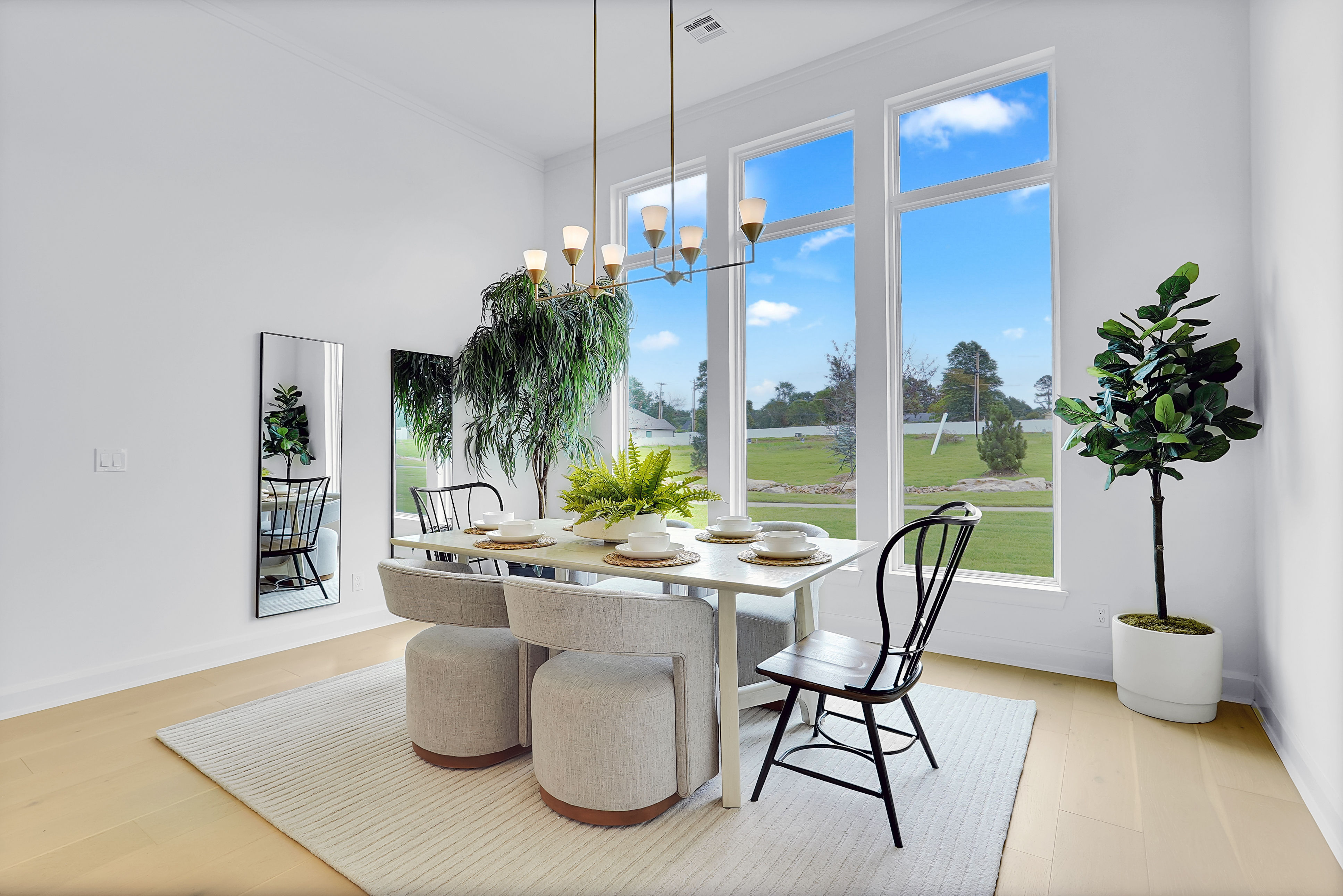 Staged kitchen and dining area with warm, modern finishes